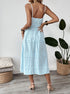 Back view of striped midi cami dress showing thin straps and smocked bodice.