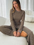 striped knit co ord set with crop top and wide leg pants sitting pose
