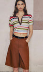 	Full-body shot of woman in colorful striped crop polo and shorts