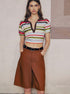 	Full-body shot of woman in colorful striped crop polo and shorts