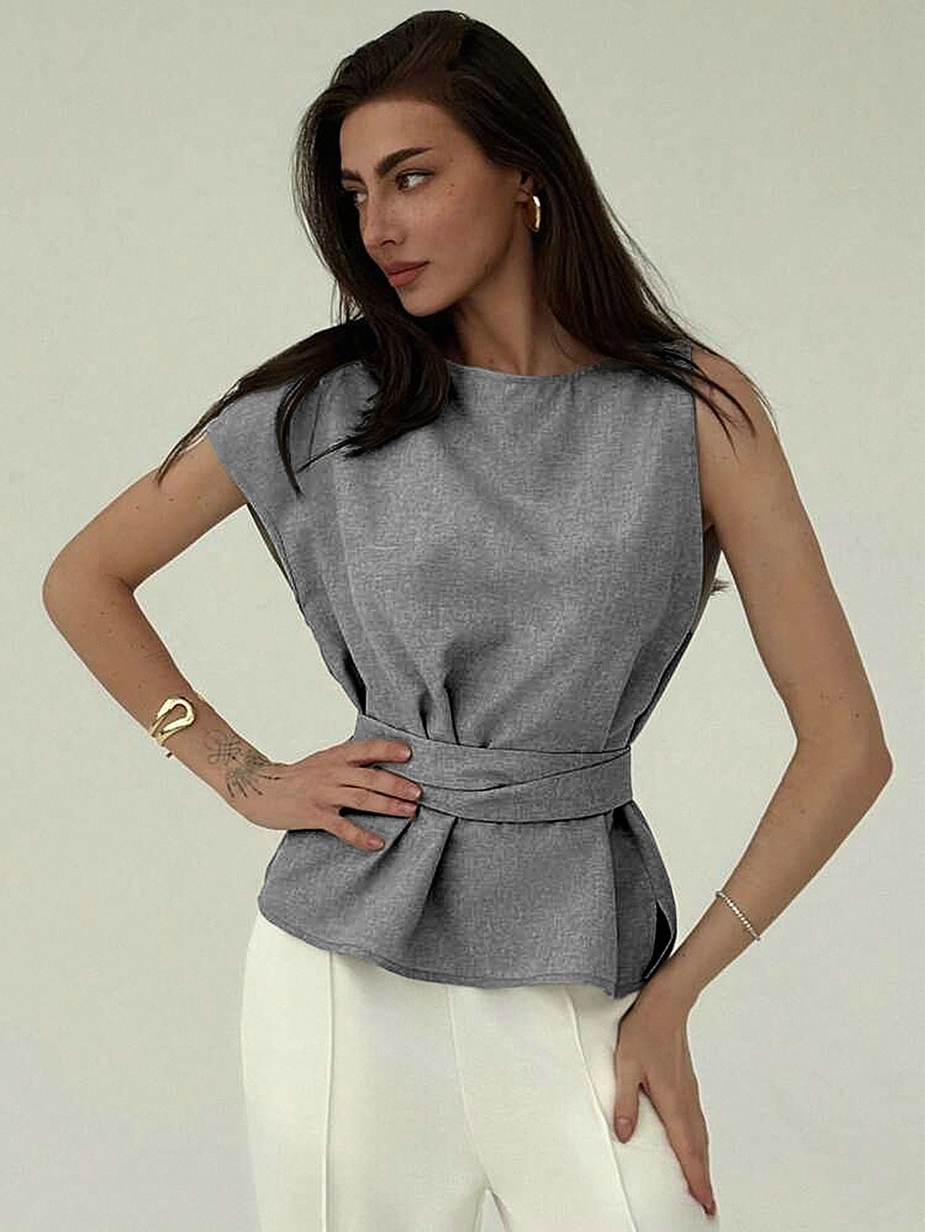 Side angle of belted gray top with structured silhouette