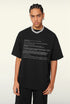 Model poses in black tee with tech-style error text across the chest.
