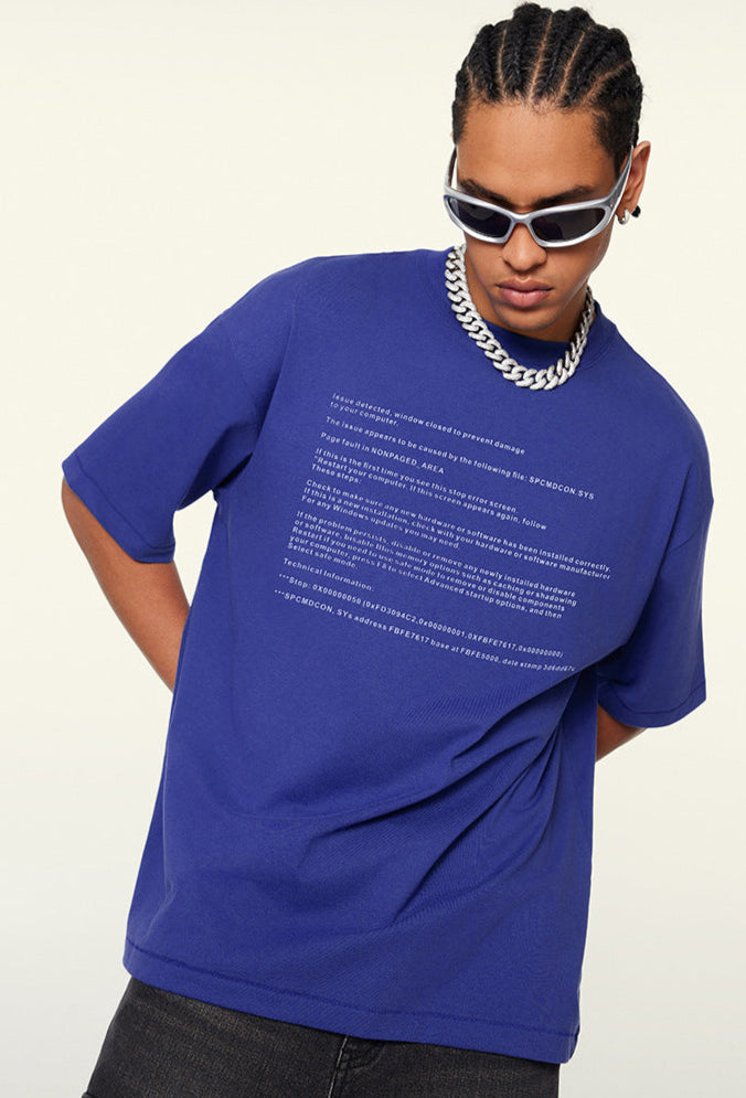 Close-up of blue tee’s collar tag showing "Designed by Be Thrived".