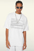 Model looks down wearing white system text tee and sunglasses.