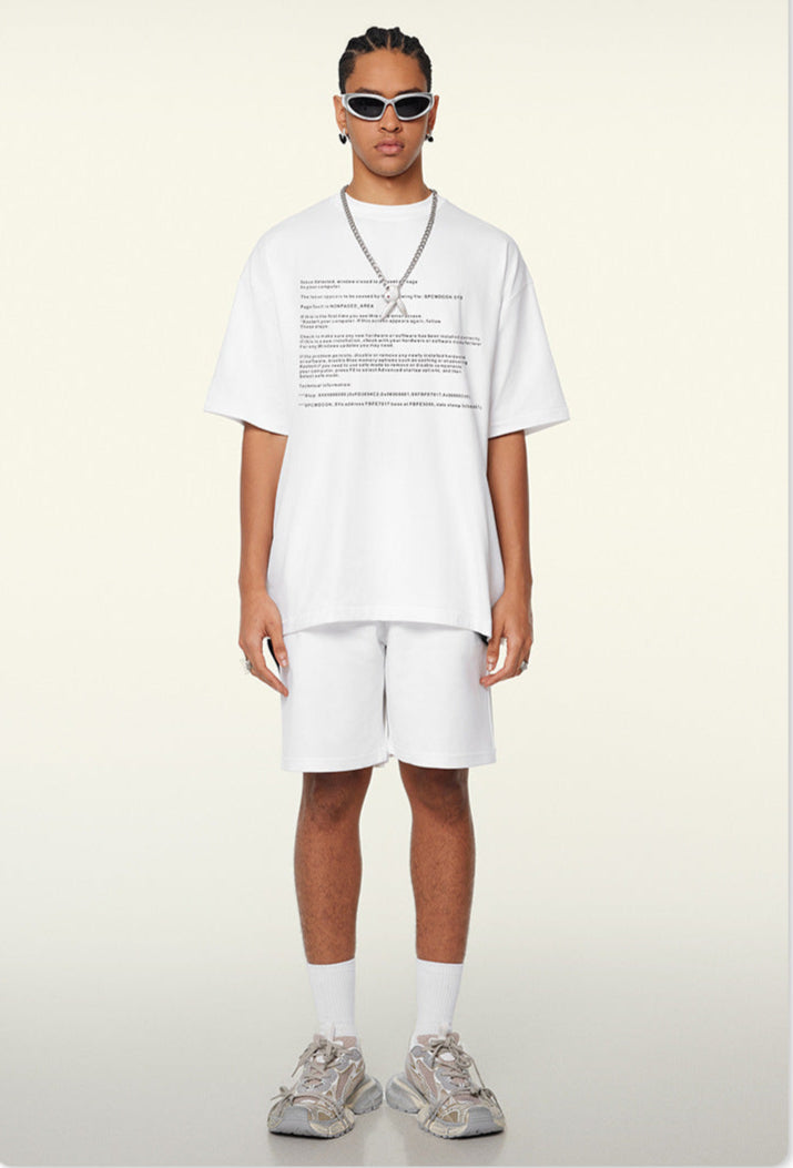 Model wears white crash report tee with white shorts and silver chain.