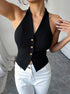 Close-up of tailored black halter top with deep neckline and button accents.