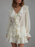 Beige ruffled blouse set worn by a model on a gray background