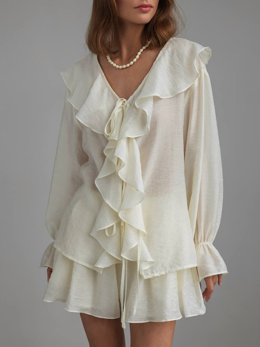 Beige ruffled blouse set worn by a model on a gray background