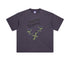 Men’s oversized purple tee with green snake-heart design and “Terrible Beauty” gothic text