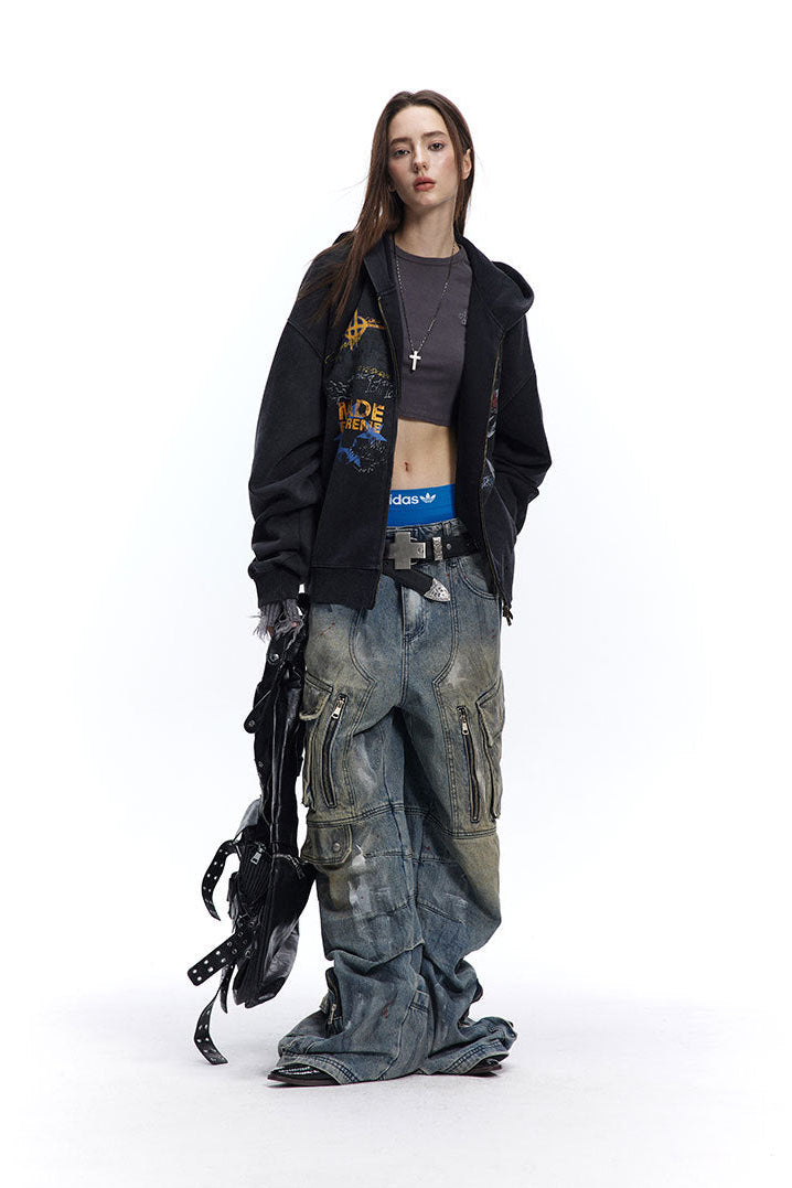 Three-quarter styling view of charcoal oversized graphic hoodie and distressed cargo denim.