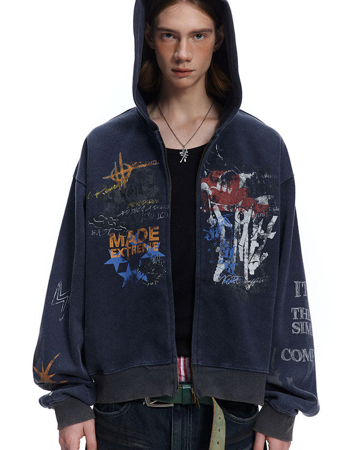 Close front view of navy oversized hoodie showing split graffiti graphics and dropped shoulders.