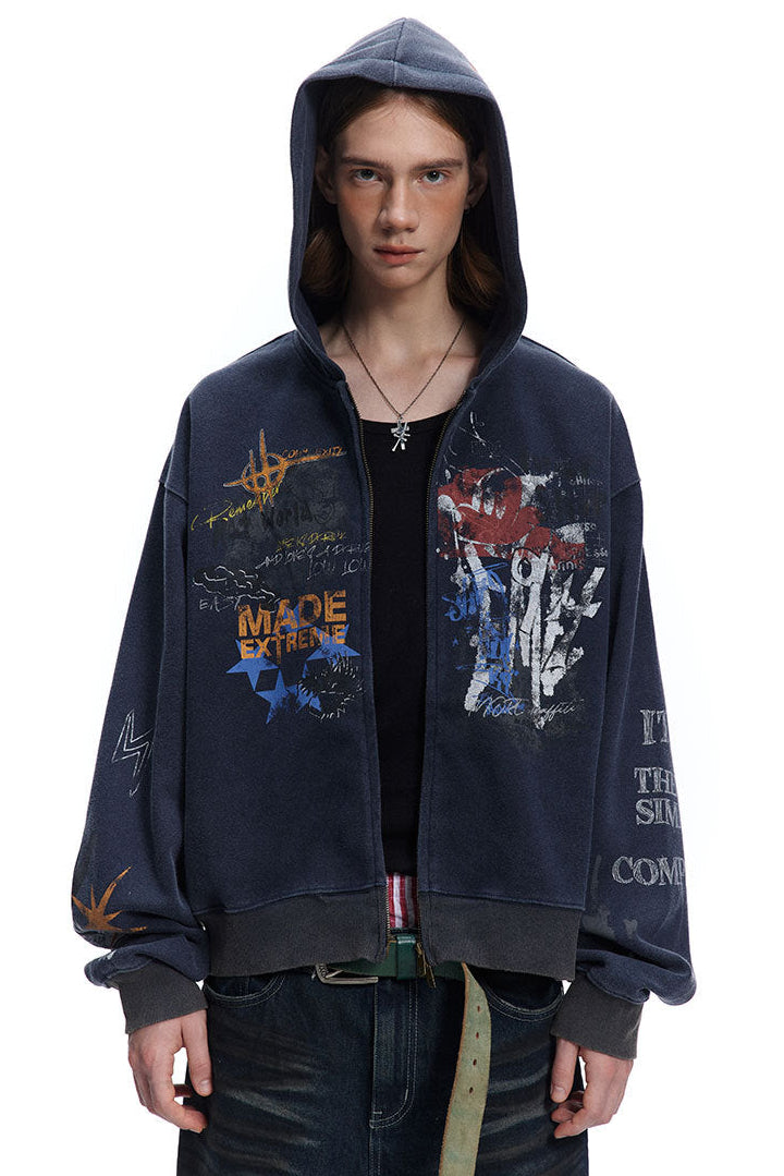 Close front view of navy oversized hoodie showing split graffiti graphics and dropped shoulders.