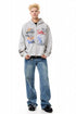 Heather gray oversized graffiti zip-up hoodie styled with wide-leg blue jeans.