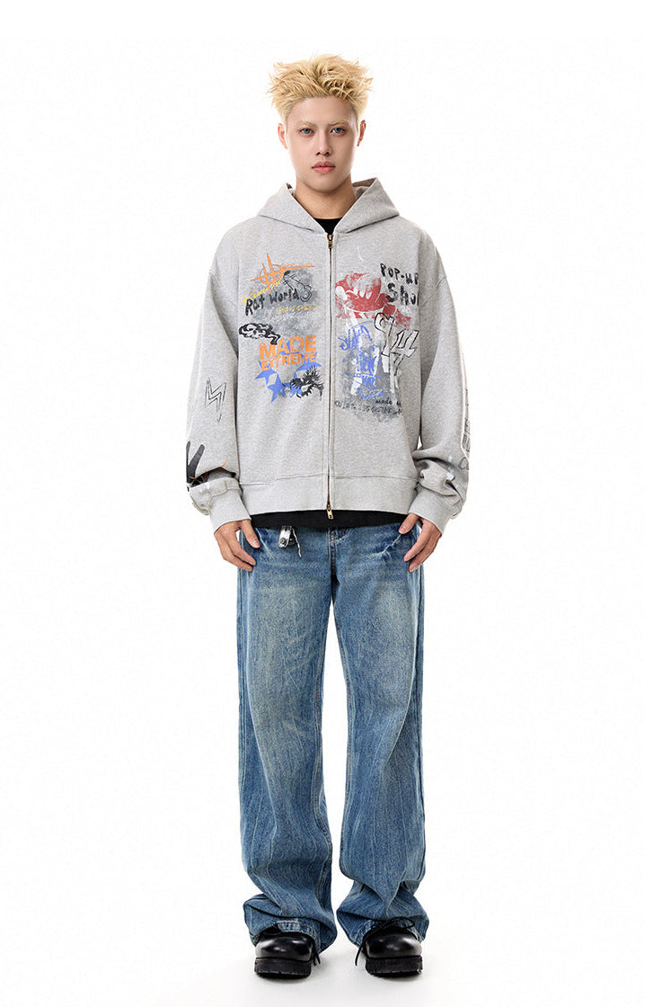 Full-length front view of heather gray graphic zip-up hoodie and relaxed denim.
