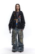 Charcoal graffiti zip-up hoodie styled open with a cropped top and wide cargo jeans.