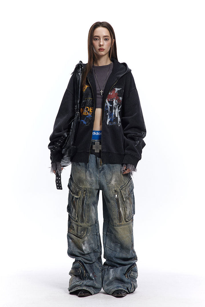 Charcoal graffiti zip-up hoodie styled open with a cropped top and wide cargo jeans.