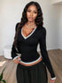 front view black V neck long sleeve top with contrast trim, slim fit, styled with skirt