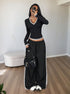 full-length black V neck long sleeve top with contrast trim, slim fit, styled with skirt