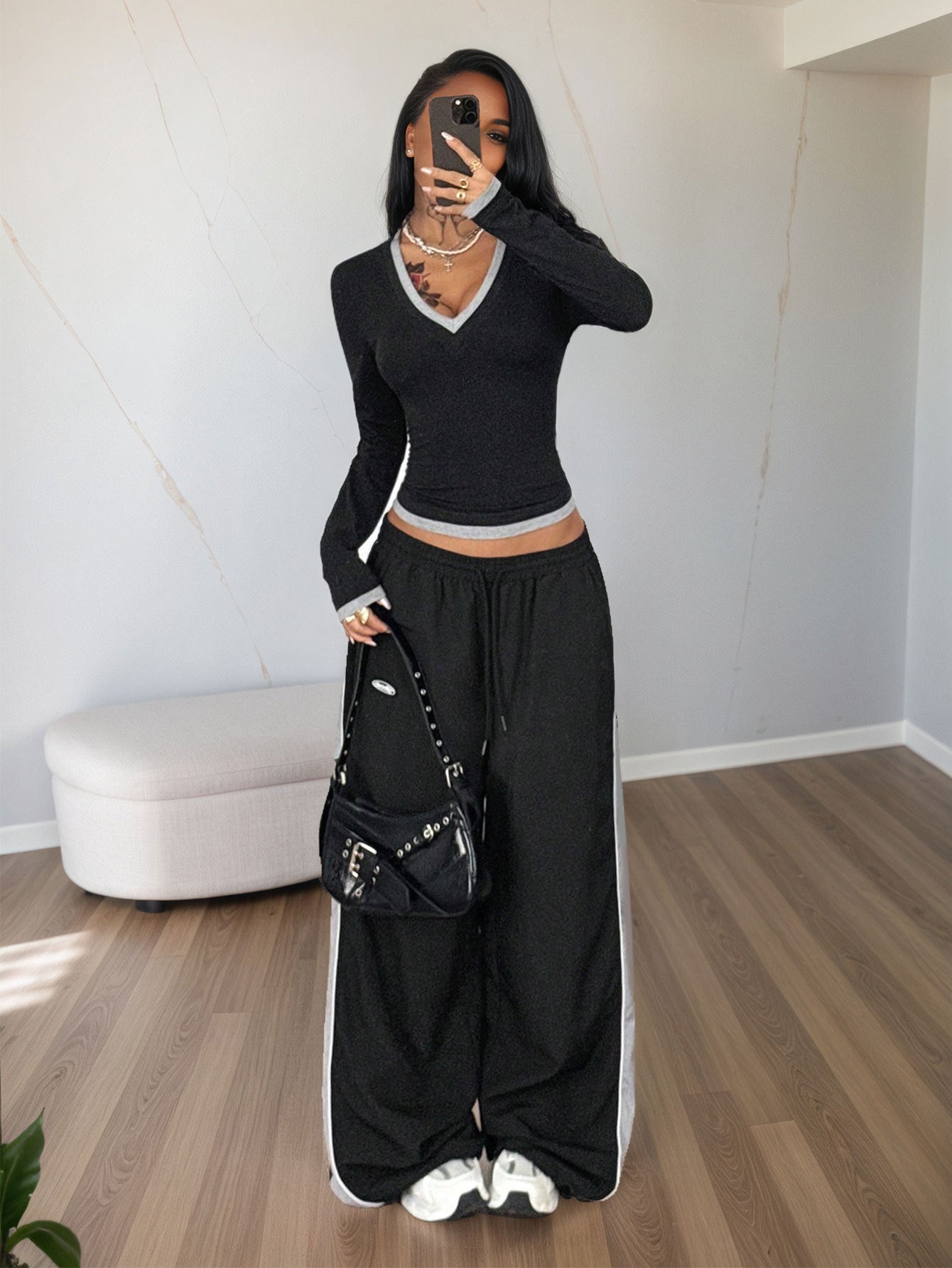 full-length black V neck long sleeve top with contrast trim, slim fit, styled with skirt