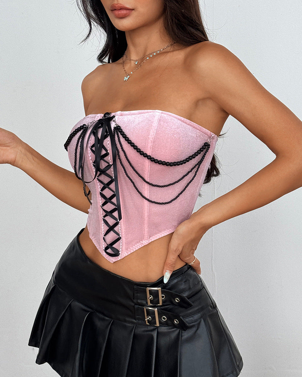 Side angle of pink bustier showing pearl chains and black lacing.