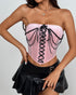 Front view of pink velvet corset styled with edgy pleated mini skirt.