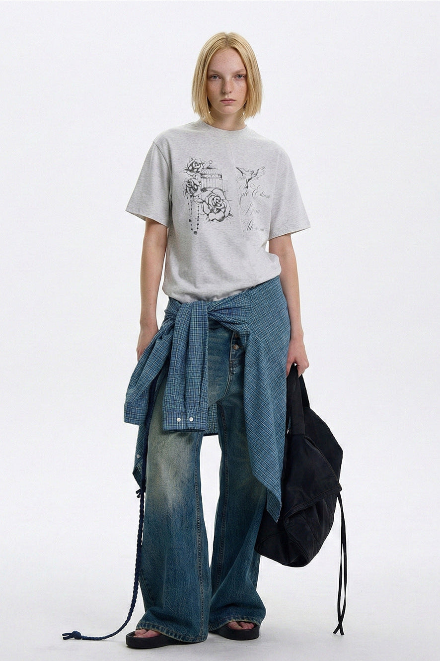 Heather gray vintage graphic T-shirt styled with wide-leg faded jeans