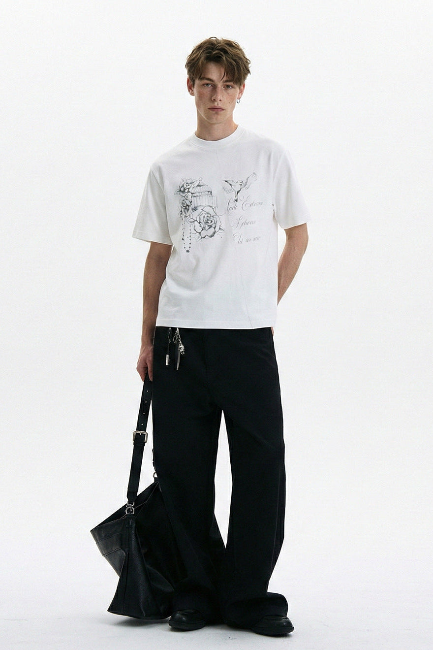 White hand-drawn graphic T-shirt styled with black wide-leg trousers