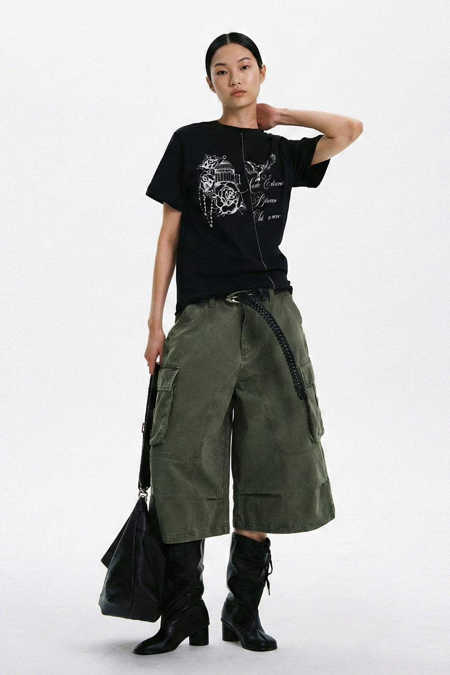 Black floral bird graphic T-shirt styled with olive cargo shorts