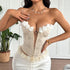 Woman posing in cream embroidered bustier with 3D flowers and satin skirt.