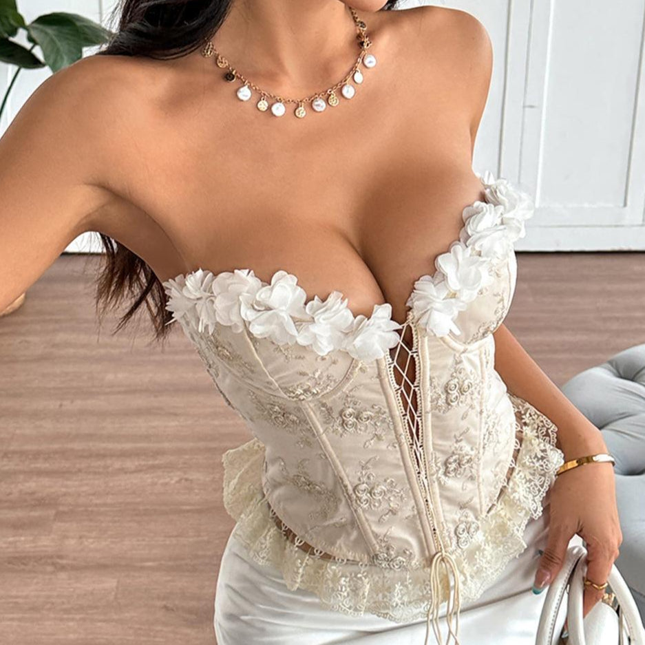 Close-up of cream floral corset with deep neckline and lace trim.