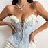 Woman in a light blue floral corset top with yellow flower trim and lace-up front, paired with a white skirt.