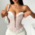Pink embroidered bustier with white floral trim and lace ruffle.