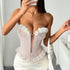 Woman taking mirror selfie in pink lace corset with 3D floral trim.