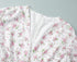 Detailed view of v-neckline and hidden zipper on floral mini dress.
