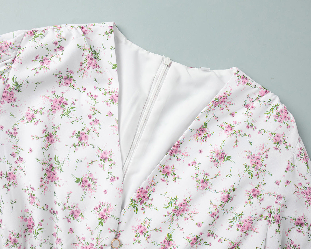 Detailed view of v-neckline and hidden zipper on floral mini dress.
