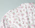White zipper and floral print detail of white mini dress with pink flowers