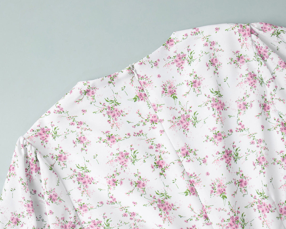 White zipper and floral print detail of white mini dress with pink flowers