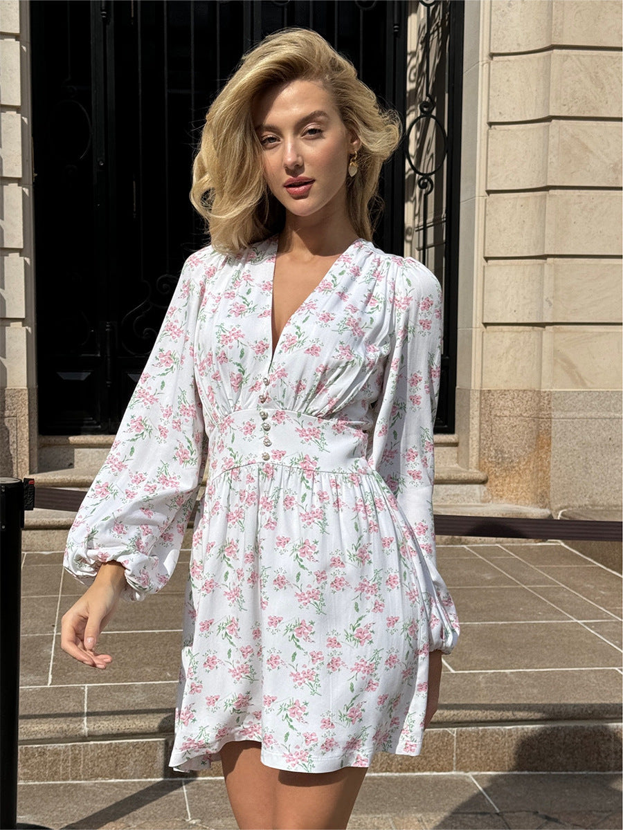 Front view of floral v-neck mini dress with puff sleeves and button details.