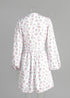 Back view of floral mini dress with zipper detail on mannequin.