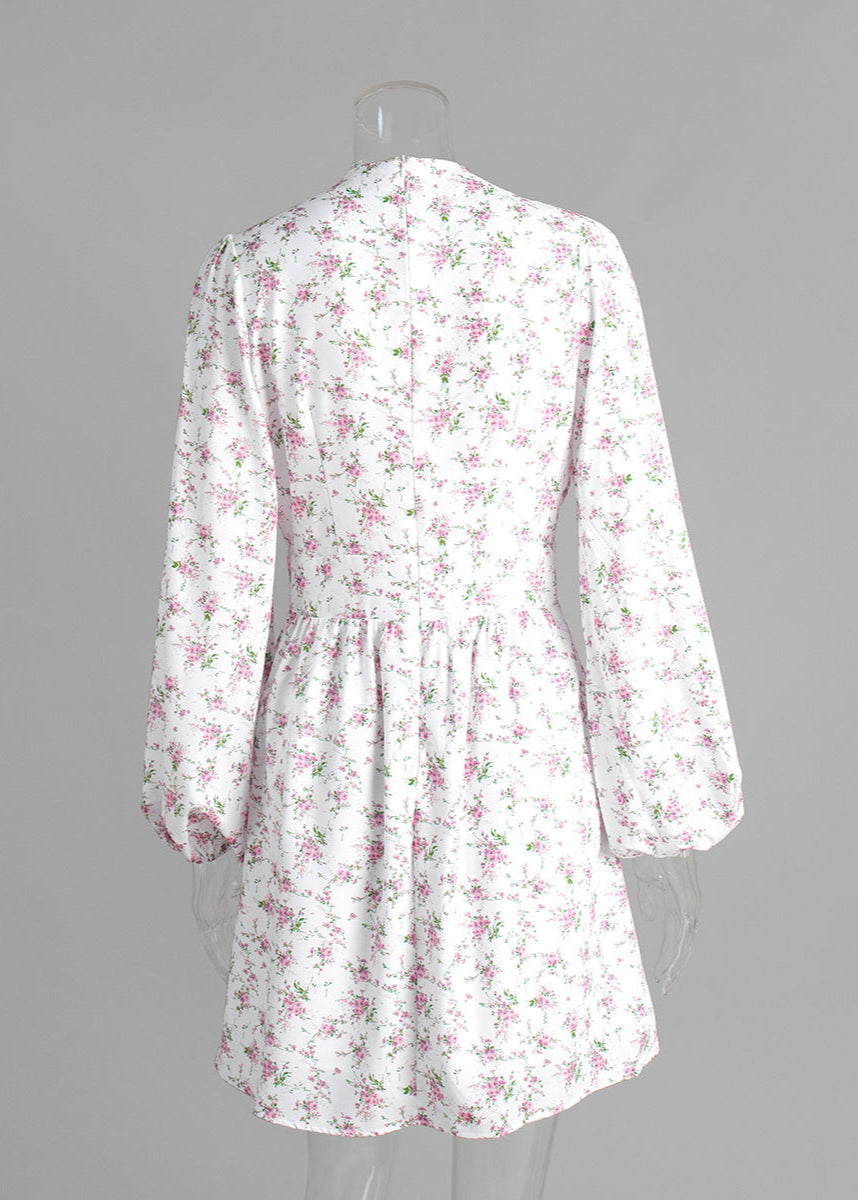 Back view of floral mini dress with zipper detail on mannequin.