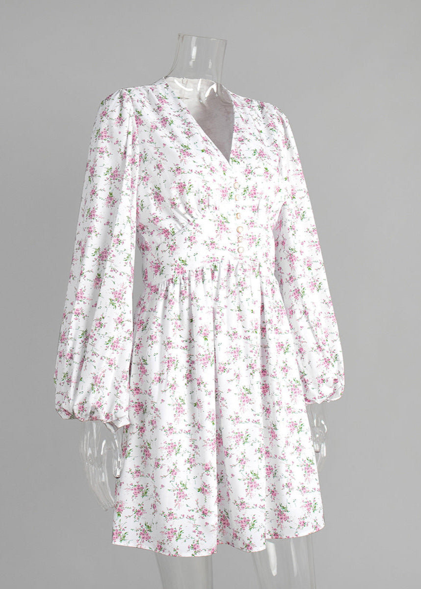 Side view of floral mini dress with zipper detail on mannequin.