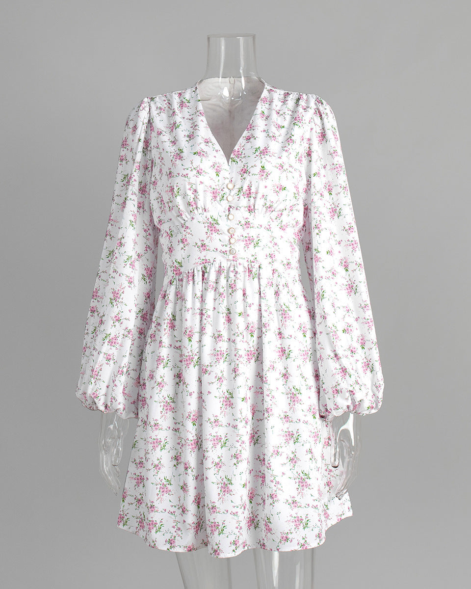 White floral mini dress with v-neck and balloon sleeves on clear mannequin.