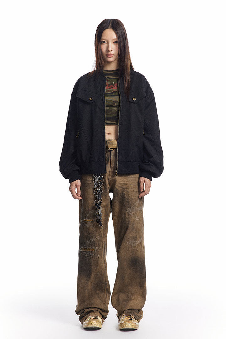 Black oversized Harrington jacket worn open with wide brown jeans