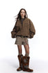 Full-length styling of brown washed Harrington jacket with shorts and tall boots