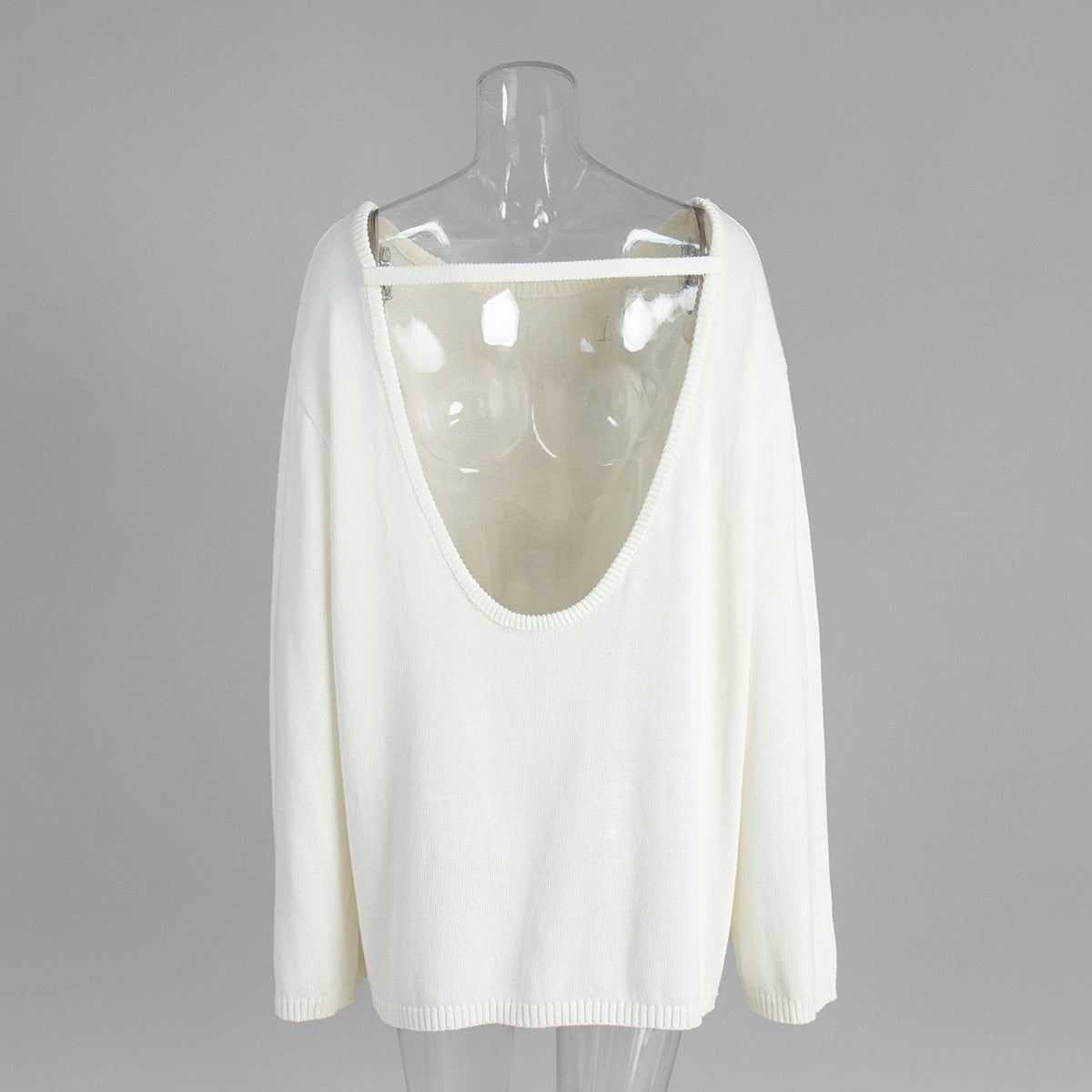 Back view of white backless knit sweater with scoop open back