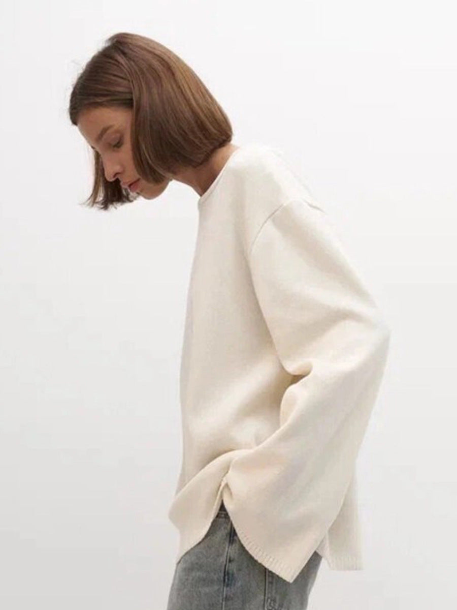 Side angle of woman wearing white backless knit sweater