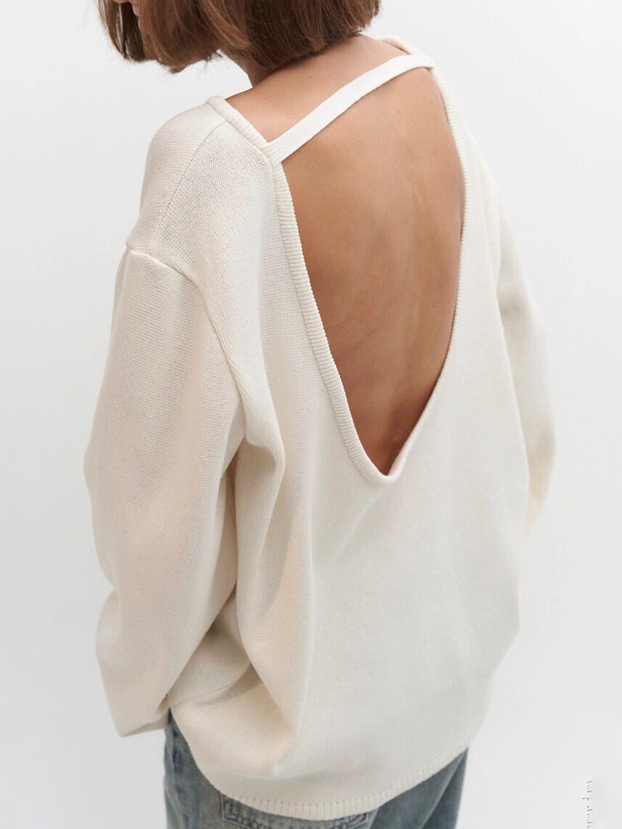 White sweater with open back worn by a person on a white background