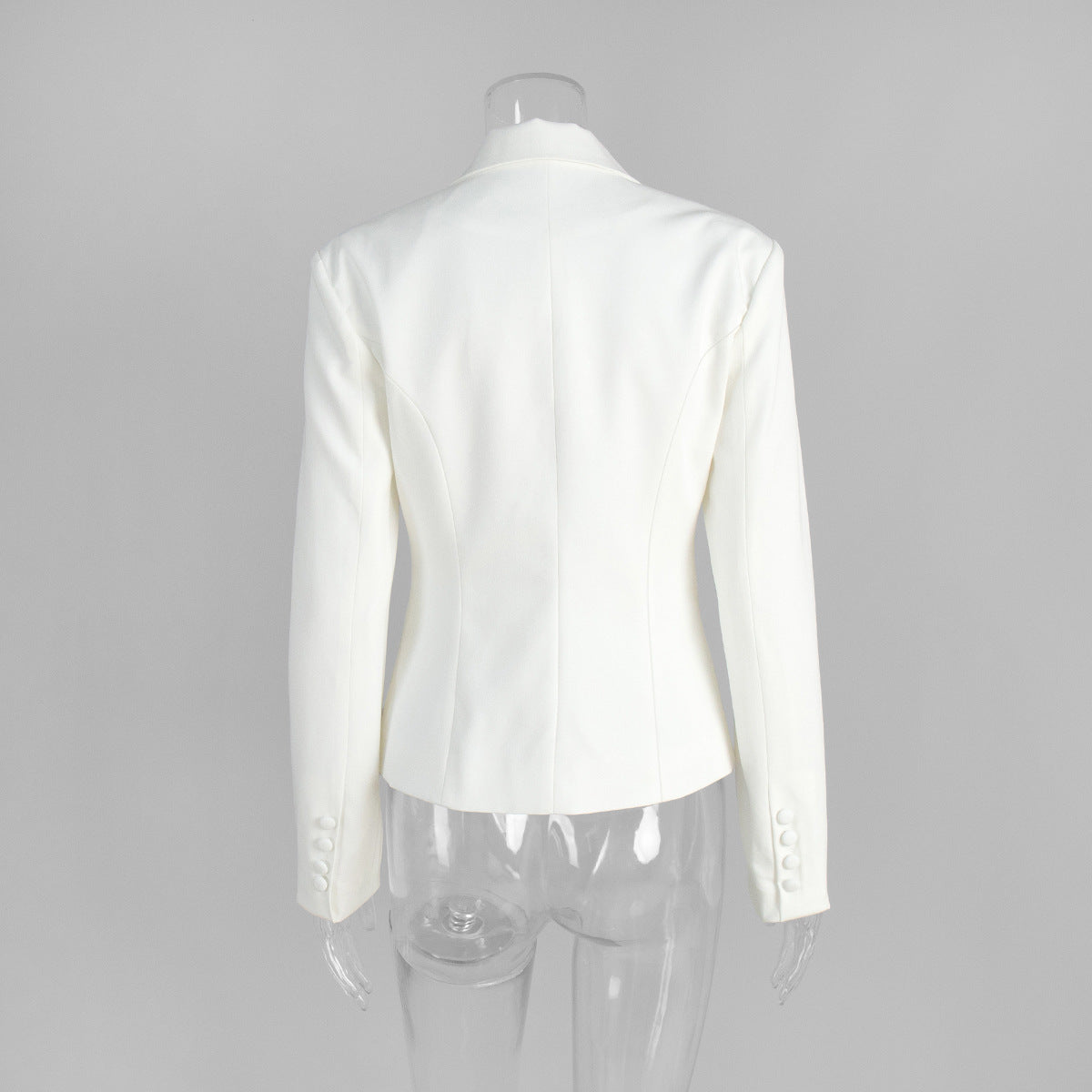 Back view of white tailored blazer displayed on mannequin