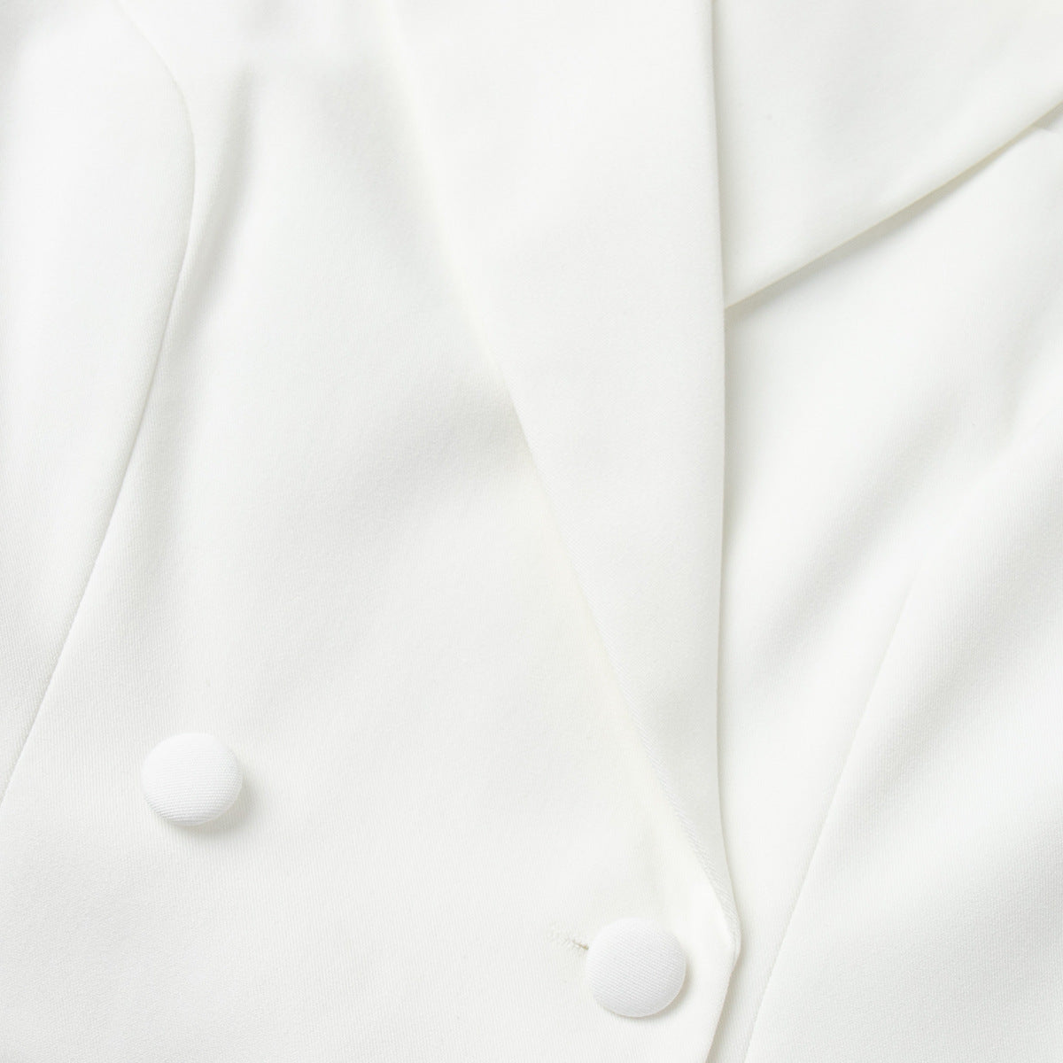 Double-breasted white blazer with button detailing