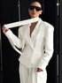 Close-up of white blazer lapel and smooth woven texture